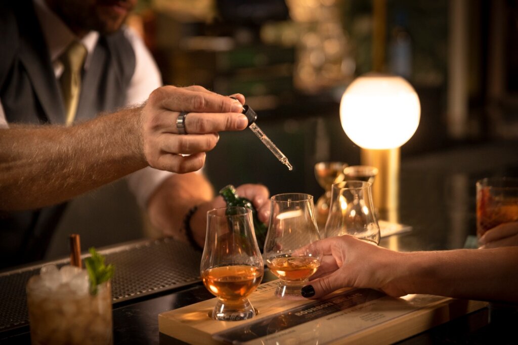 Bartender Adding Water To Whiskey Flight at Huntress