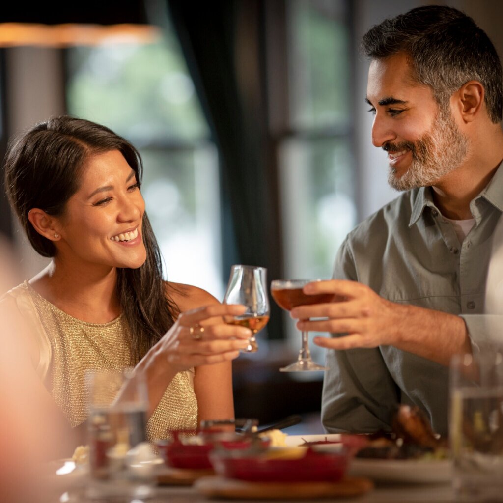 Woman With Whiskey Cheersing Man With Wine Spectator Award Wine At Huntress