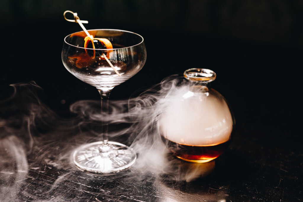 Huntress Signature Whiskey Cocktail Smoking Before Being Poured